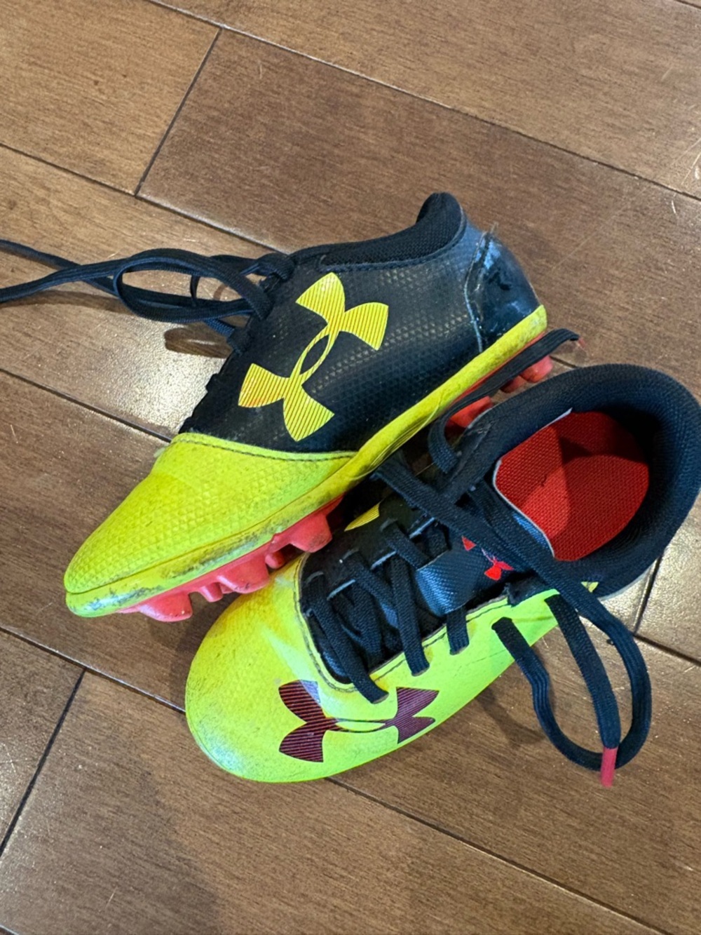 Under Armour Kids' Yellow and Black Soccer Cleats with Red Accents